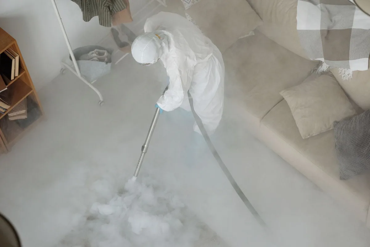 Biohazard cleanup technician in protective equipment, Garnett, KS